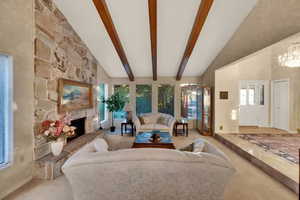 Formal Living Room with tons of light from large front windows, impressive custom fireplace and beamed vaulted ceilings.