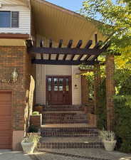 Beautiful front door entry featuring brick stairs