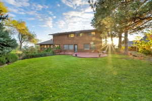 Spacious backyard and view of large deck and BBQ area.  Upper level of yard.