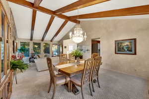 Dining room with carpet floors and a chandelier
