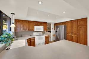 Bright & happy kitchenwith large windows, lots of light, view of back yard and recessed lighting.