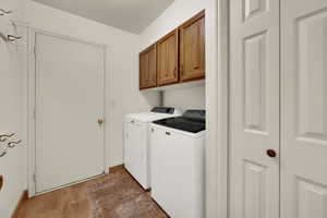Main Floor Laundry featuring upper cabinets and extra closet space!