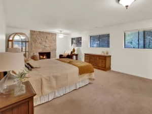 Spacious Master Bedroom with extra room for cozy seating and a beautiful Custom Fireplace.