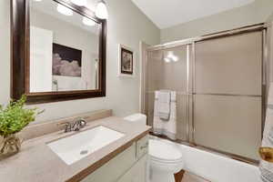 Full bath with vanity and shower / bath combination with glass door