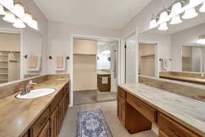 Generous Master Bathroom with two oversized counters & mirrors, & separate tub and toilet.