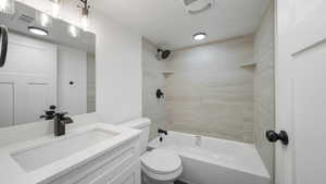 Bathroom with vanity and shower / tub combination