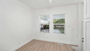 Empty room featuring baseboards and light wood-style flooring