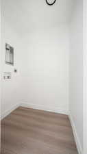 Laundry room with wood finished floors, washer hookup, and electric dryer hookup