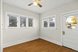 Foyer entrance featuring wood finished floors and a ceiling fan