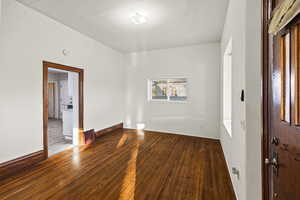 Spare room featuring hardwood / wood-style flooring and baseboards