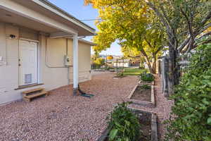 Fenced backyard featuring a garden