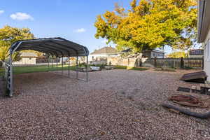 View of yard with an outbuilding and a carport