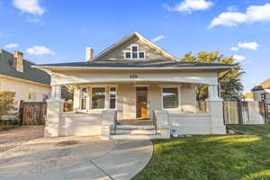 View of front of house featuring covered porch and brick siding