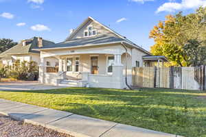 Bungalow-style house with covered porch, brick siding, a chimney, and roof with shingles