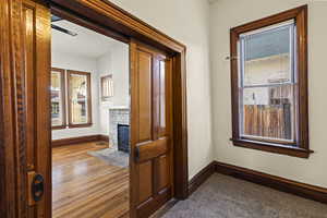 Corridor with healthy amount of natural light and dark wood-style floors