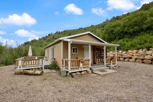 View of front of property featuring the mountain and trees.