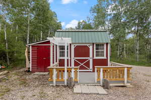 Isn't the bunkhouse adorable? The lean-to on the left houses yard tools. Notice the metal roof.