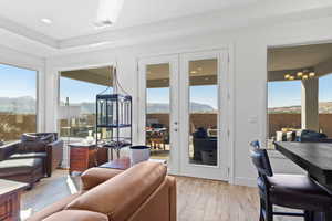 Living area featuring french doors, light wood-type flooring, a mountain view, and recessed lighting