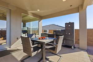 View of patio with outdoor dining area and grilling area