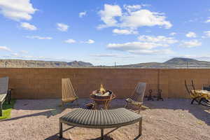 View of patio featuring a mountain view and an outdoor fire pit
