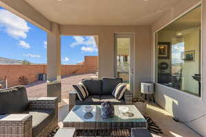 Fenced backyard featuring a patio and an outdoor lounge area