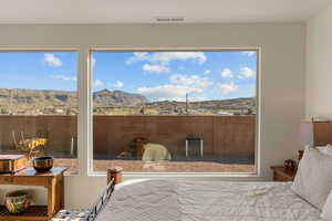 Bedroom with a mountain view and multiple windows