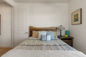 Bedroom featuring wood finished floors and baseboards