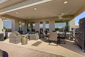View of patio with an outdoor living space, outdoor dining space, and french doors