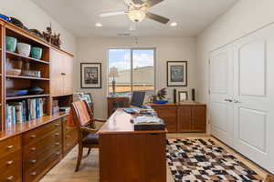 Office area with a ceiling fan and recessed lighting