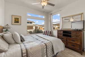 Bedroom with a ceiling fan and light wood-style flooring