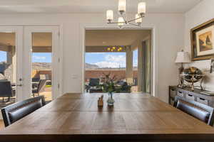 Dining area featuring french doors, healthy amount of natural light, a mountain view, and hanging lights
