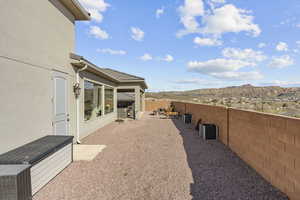 Fenced backyard with a mountain view and a patio area