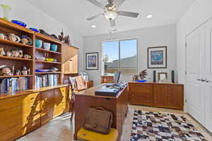 Office with recessed lighting and ceiling fan