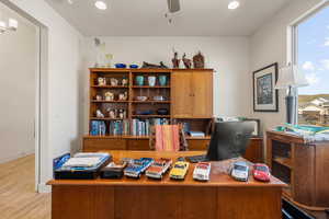 Office featuring light wood-style floors, ceiling fan, and recessed lighting