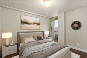 Virtually stages bedroom featuring wood finish floors and a textured ceiling