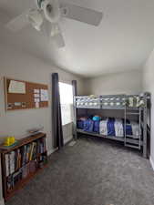 Bedroom with carpet, ceiling fan, and a textured ceiling