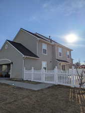 Back of property featuring stucco siding