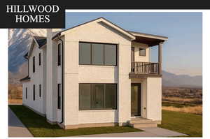 View of front of house featuring a balcony, a mountain view, a front yard, and brick siding