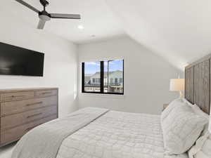 Bedroom with a ceiling fan, vaulted ceiling, and recessed lighting