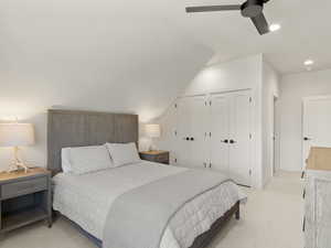 Bedroom featuring two closets, light carpet, recessed lighting, vaulted ceiling, and ceiling fan