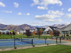 View of tennis court featuring a mountain view and a residential view