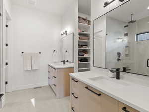 Bathroom with a stall shower and two vanities