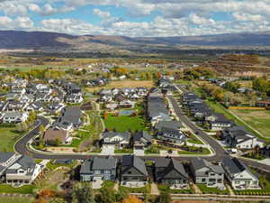 Aerial view of property's location featuring a mountainous background and nearby suburban area