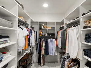 Walk in closet with light carpet