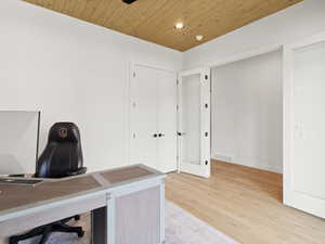 Unfurnished office with wood ceiling, light wood-type flooring, and recessed lighting