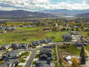 Aerial view of property's location with nearby suburban area and a mountainous background