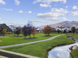 View of property's community featuring a mountain view, a yard, and a residential view