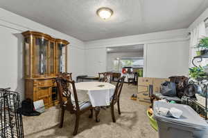 Dining area with carpet and a textured ceiling