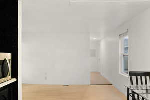 Hallway featuring light wood-style flooring