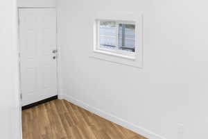 Doorway featuring wood finished floors and baseboards